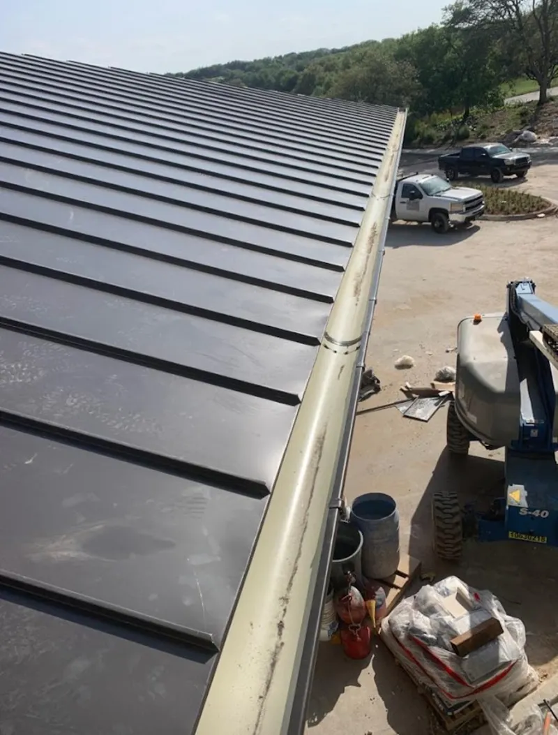 Standing seam panel and gutter detail on a metal roofing jobsite in Wahoo